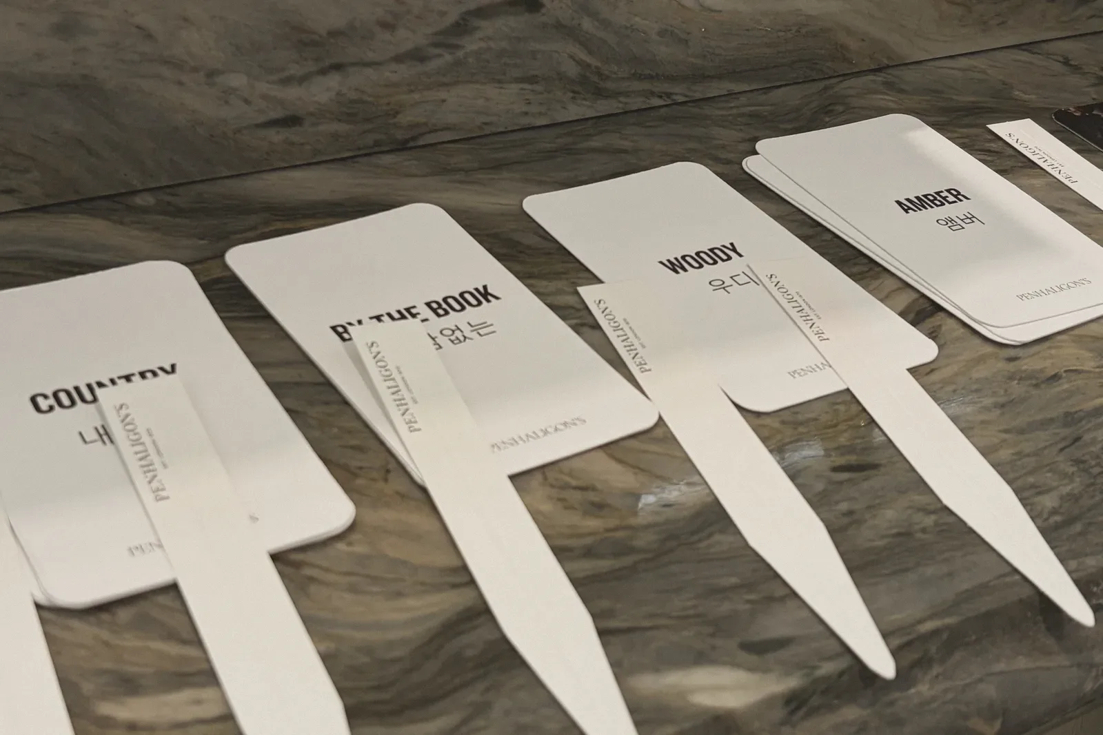 Blank name-tag cards laid out on a wooden table.