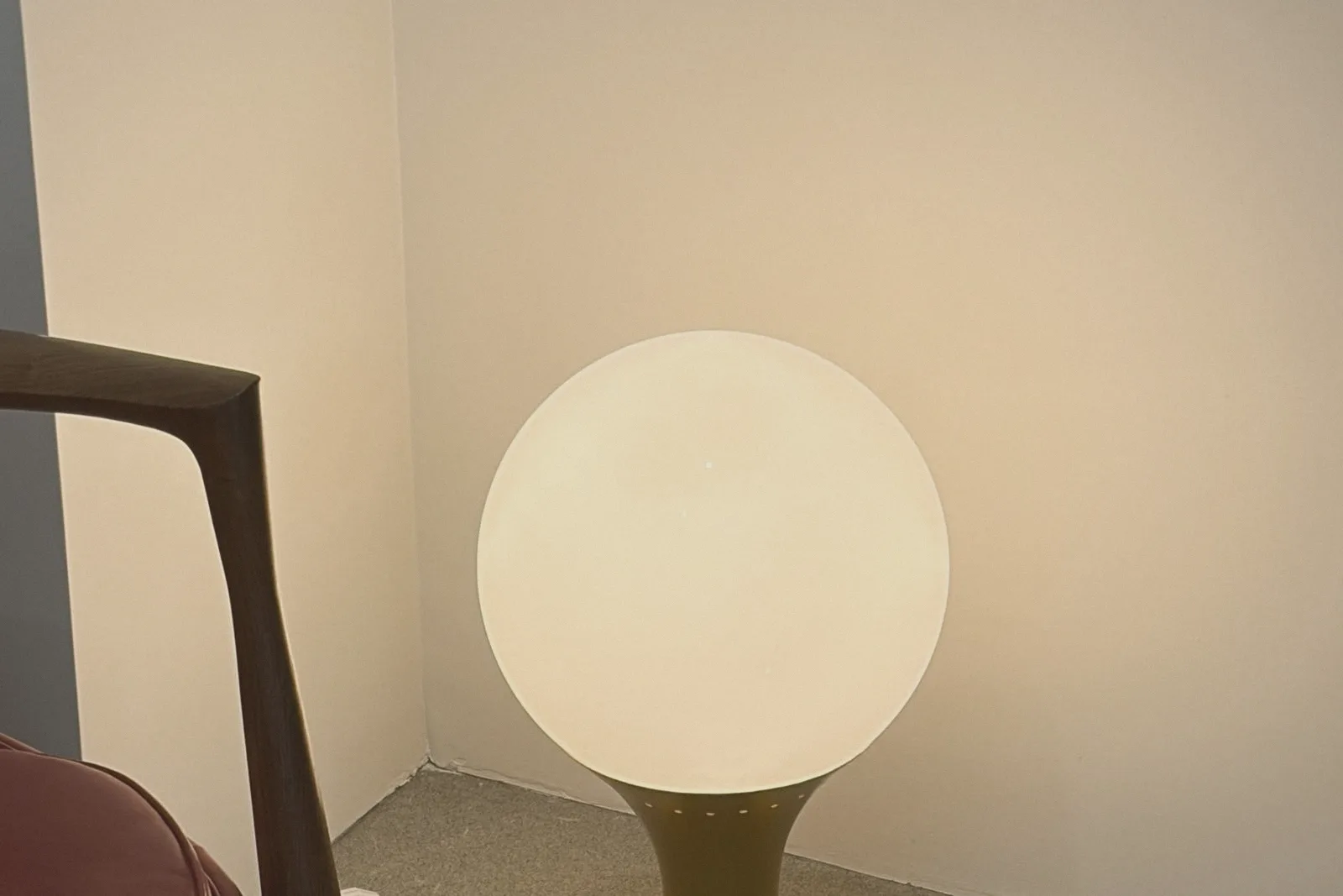 A glowing glass globe lamp in warm evening light.
