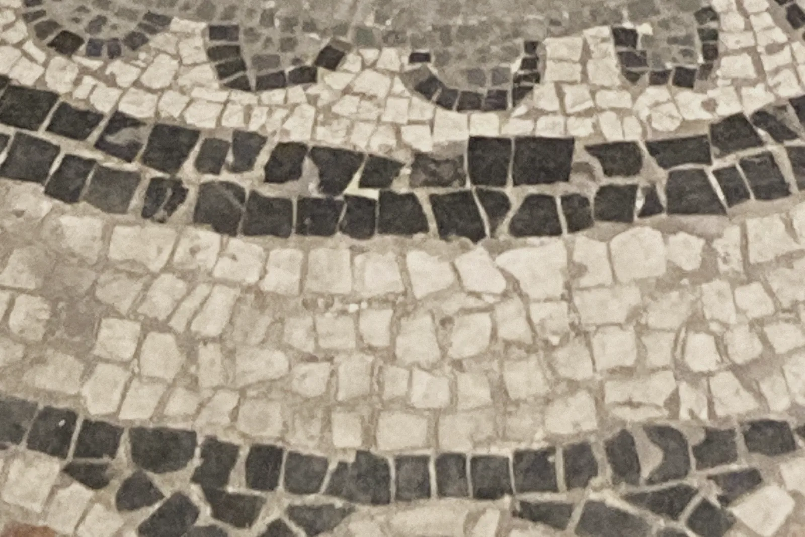 Close-up of mosaic tiles set tightly together like bricks and mortar.