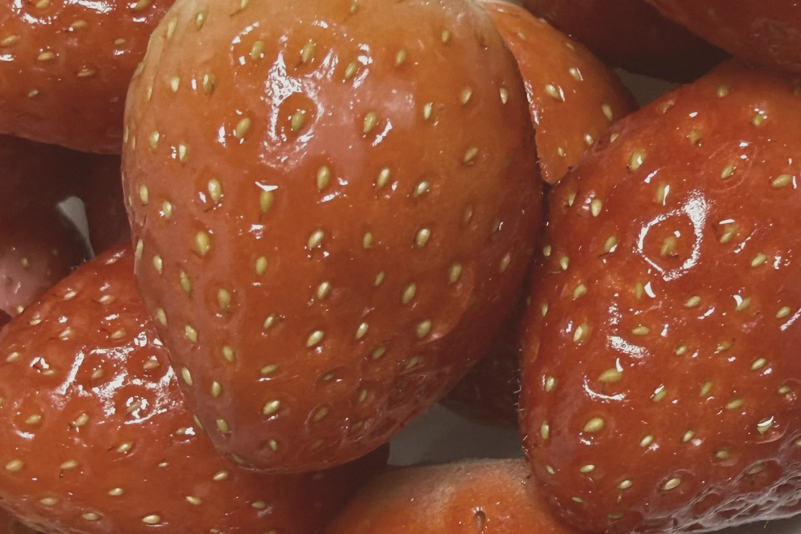 Close-up of fresh strawberries, their skin dotted with seeds.