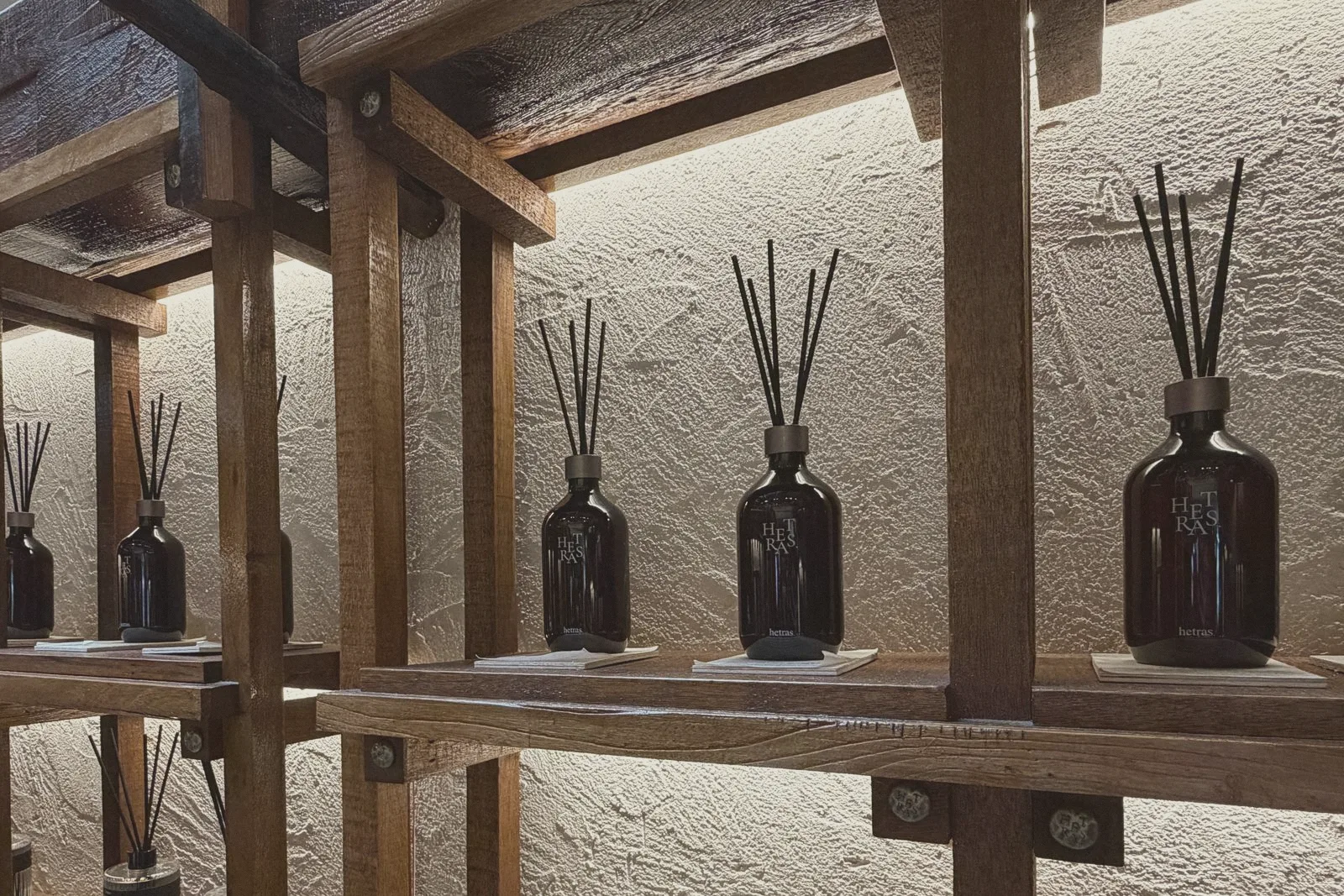 Amber glass bottles lined up on wooden shelves.