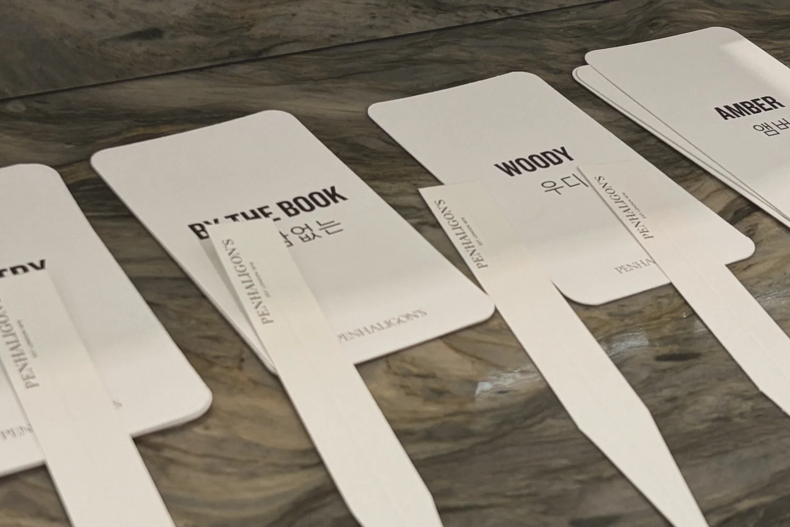 Paper fragrance testing strips laid out on stone.